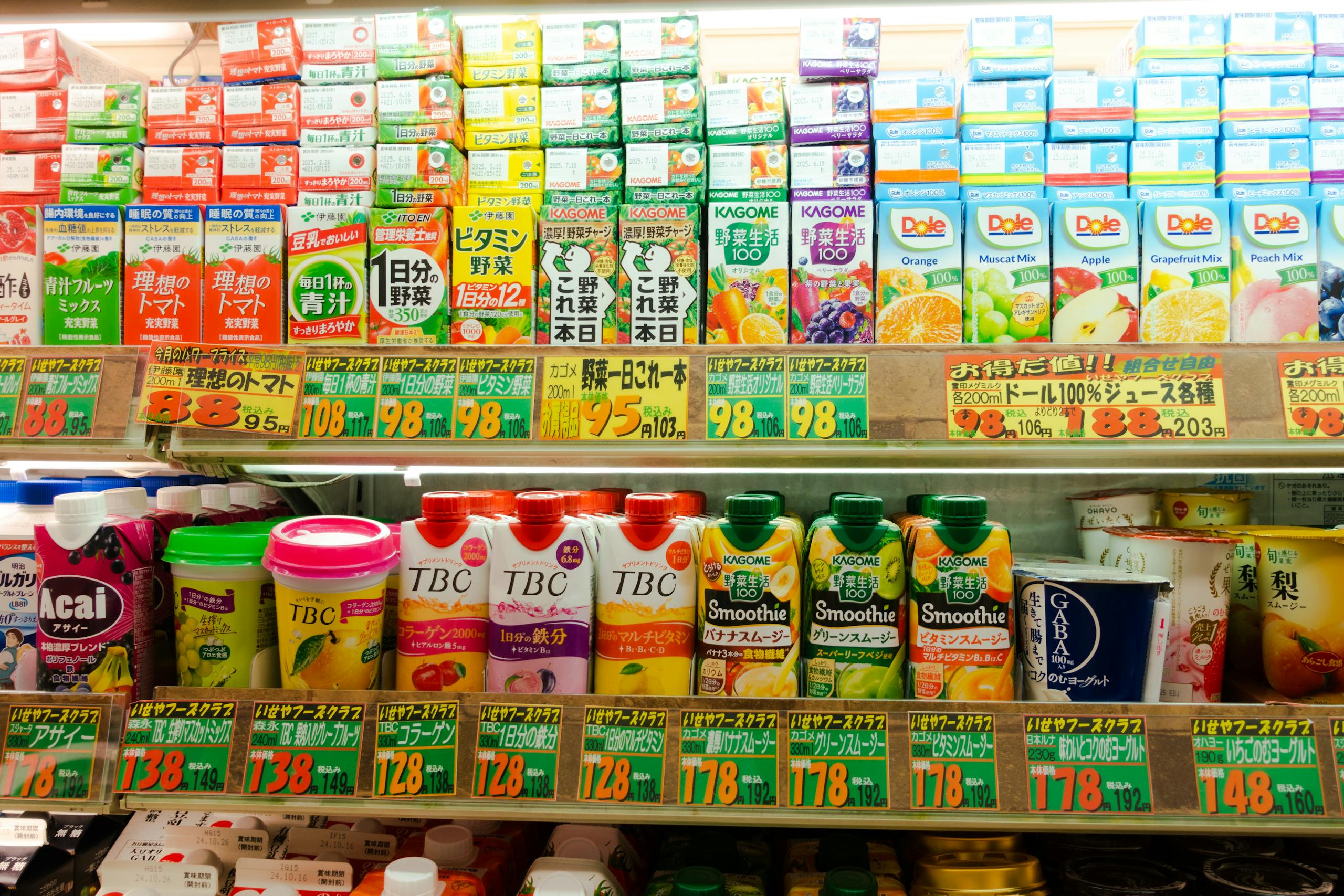 Colorful assortment of Japanese drink cartons and bottles in a convenience store aisle.