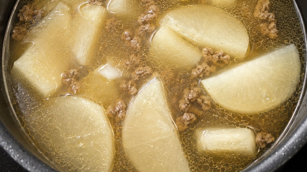 Vietnamese daikon soup with ground beef simmering in a pot